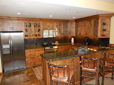 Fully-equipped kitchen with granite countertops and stainless steel appliances.