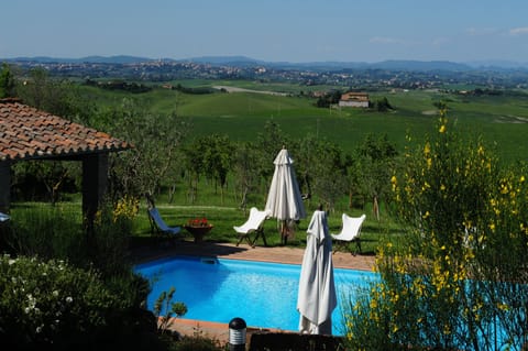 Relax by the pool while enjoying the view of beautiful Siena