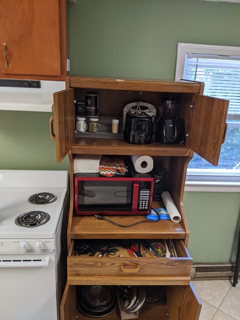 More cookware in drawers beside the sink. Grill under cabinet on side porch.
