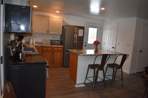 Kitchen and bar seating area 
as seen from the left of the entry doors.