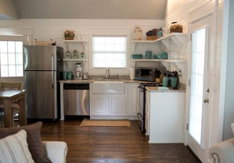 Open shelving in farmhouse style country kitchen in vacation rental