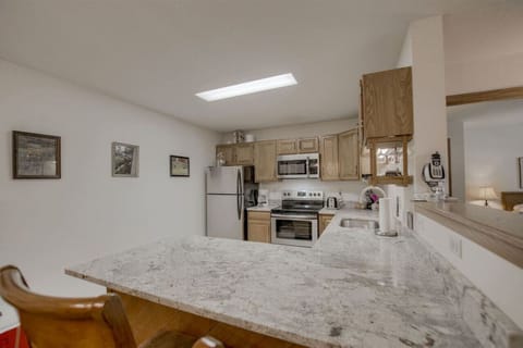 The kitchen is fully equipped with modern appliances and basic spices