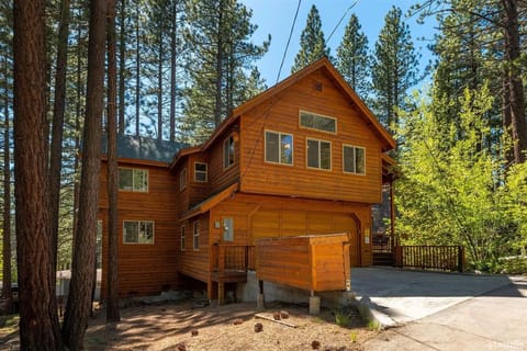 Front of Tahoe Belle in Spring showing 2 car driveway and garage door. 