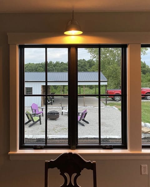 Looking out the sunroom to the fire pit and pavilion 