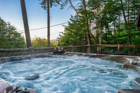 Relax outside in the hot tub with mountain views!