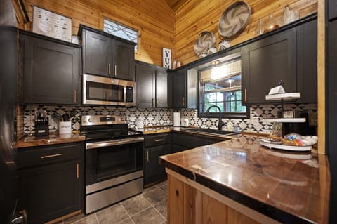 The kitchen is small, but fully stocked with full sized appliances!