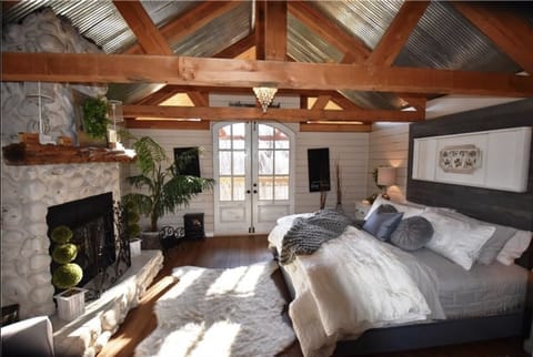 Luxurious master bedroom with double french doors opening to large deck