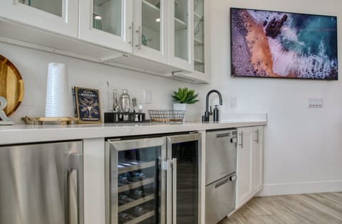 bar appliances including a gourmet ice maker, bev/wine, sink and dishwasher