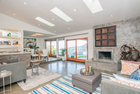 Featuring entertaining bar, fire place and serene views.