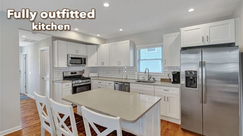 The kitchen features serving set for 12, coffee maker, microwave, oven & fridge.