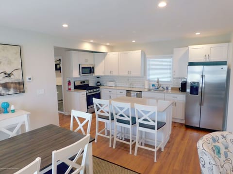 Open concept space features a new kitchen, large island & kitchen table for 6. 