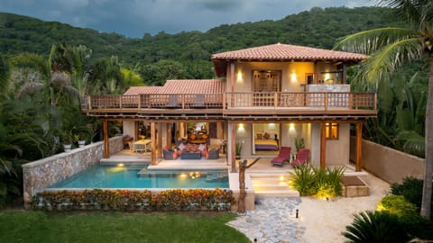 Twilight picture of the back of the house, steps away from the ocean!