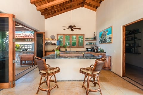 Fully stocked kitchen, island with 2 swivel chairs.