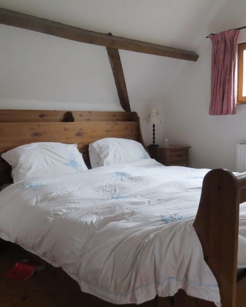 King size bed in La Fermette, with en suite bathroom.