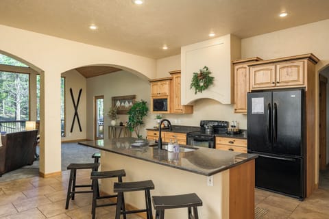 Gather Around the Kitchen Bar:
The spacious bar top is the perfect place to chat and sip drinks while the chef of the group works their magic.