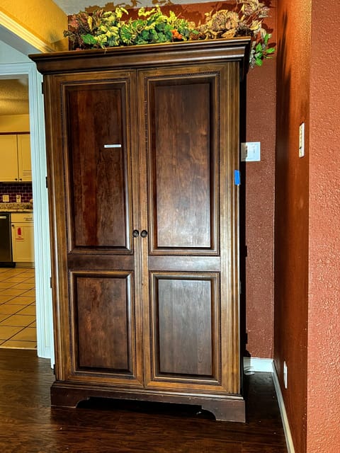 Armoire containing books, games,  and etc. for guest entertainment.  