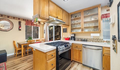 Kitchen area with Cuisinart drip coffee maker, dishwasher, microwave, and more.
