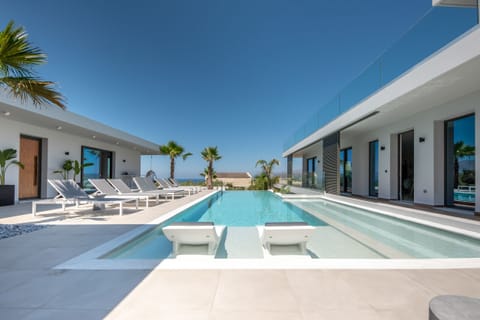 A heated pool, sun loungers