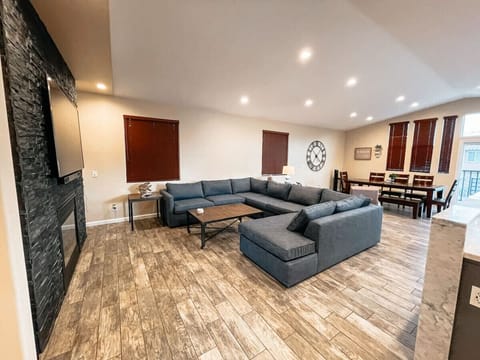 Open concept living area with large couch that also has a pull out sofa bed.