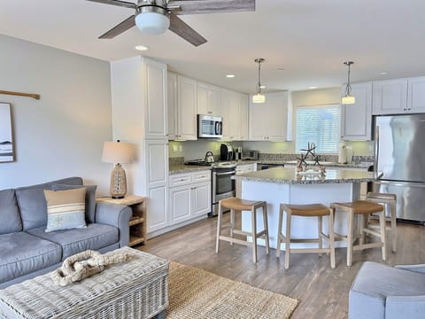 A bright, open living space flows into a chef-grade kitchen, complete with high-end appliances — the perfect blend of style, comfort, and coastal charm.