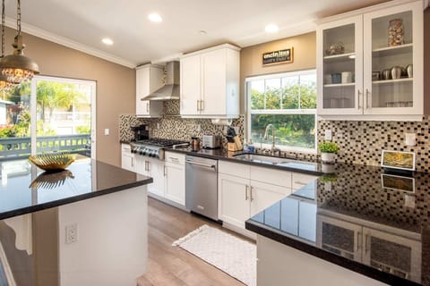 The modern kitchen is equipped with high-end appliances and all the tools