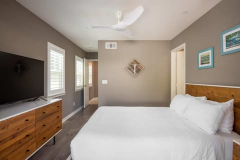 A "surfer crossing" graphic hangs in the second guest bedroom.