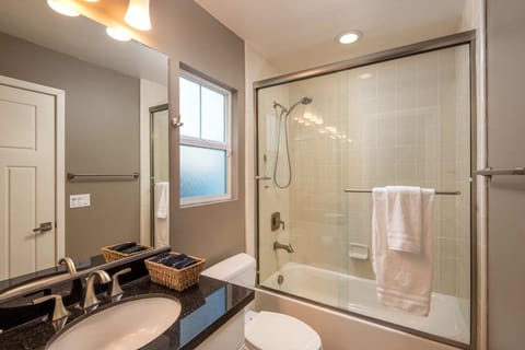 The Jack and Jill bathroom is finished with sleek, new appliances. The tub/shower combo allows you to choose between steaming or soaking.