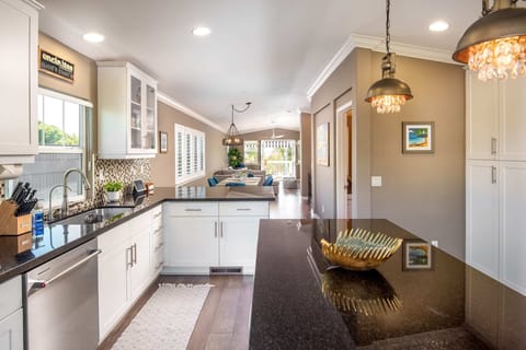 The open floor-plan seamlessly connects the kitchen, dining, and living areas on the top level.