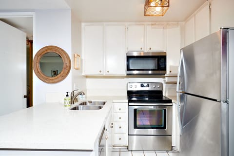 The kitchen is equipped with dishes, pots and pans, and cooking utensils.