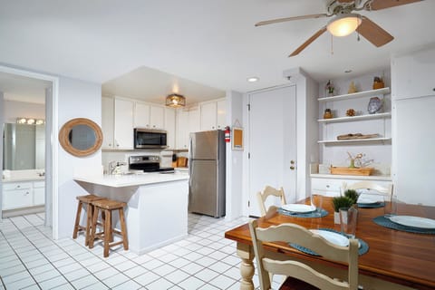 The dining table seats 4, plus 2 bar stools.