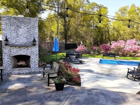 We provide the firewood for the Outdoor Fireplace.  Azaleas blooming around pool