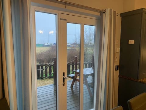 French Doors Leading from Kitchen Diner to Decking area with View over the Braid