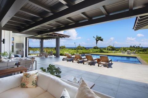 Outdoor living space and pool with ocean views.