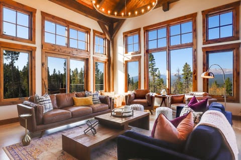Main floor living room with mountain views and wood burning fireplace