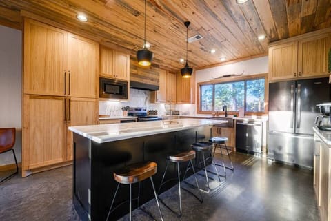 Modern rustic kitchen with quartz counters and stainless appliances.