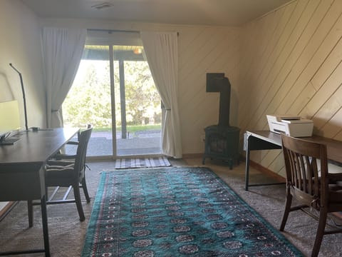 Two desks, task lights, a monitor, printer, and shredder. Walk out to the yard.