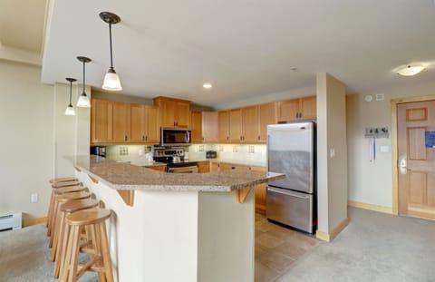 The kitchen features bar stool seating.
