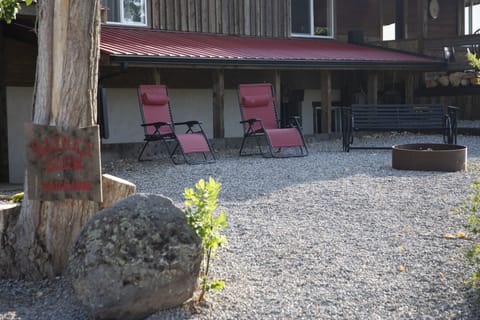 View of home and fire ring from parking area