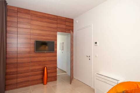 LCD TV in a bedroom with en suite bathroom of a Croatia luxury villa Trogir 1 for vacation and rent on Ciovo