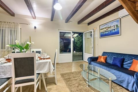Comfortable sofa and dining table with direct entrance to the terrace of the family vacation villa Dalmatino Trogir with the private pool right at the beach