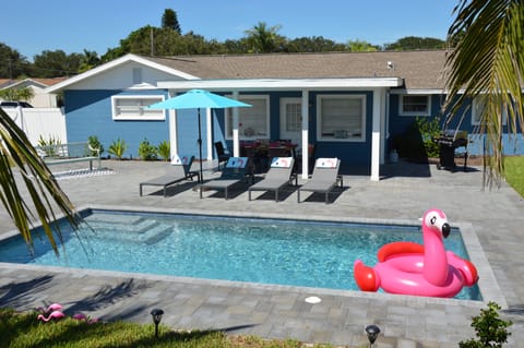 A heated pool, sun loungers