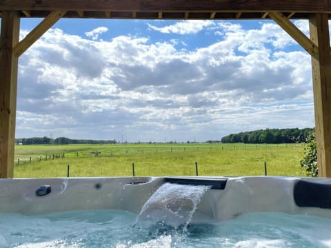 Relax the night away in our hot tub overlooking the peaceful surroundings of farm country!! During certain periods of the year, there will be cows grazing the field directly behind house!