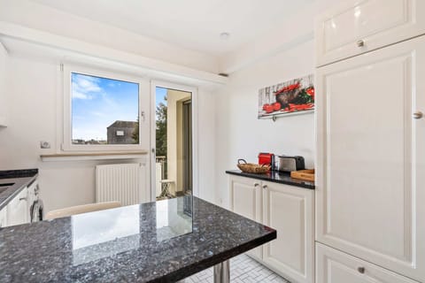 Bright kitchen with modern appliances and plenty of counter space, perfect for preparing and enjoying meals.