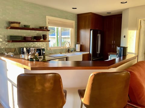 Open kitchen with breakfast/cocktail bar for casual meals or socializing