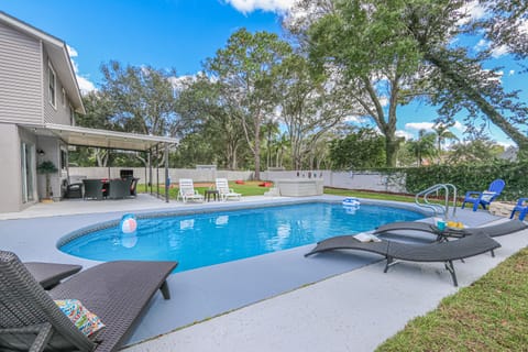 Enjoy a relaxing day poolside in the large private backyard