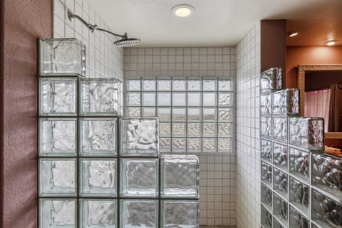 Large walk-in glass shower with views of Joshua Tree while maintaining privacy.