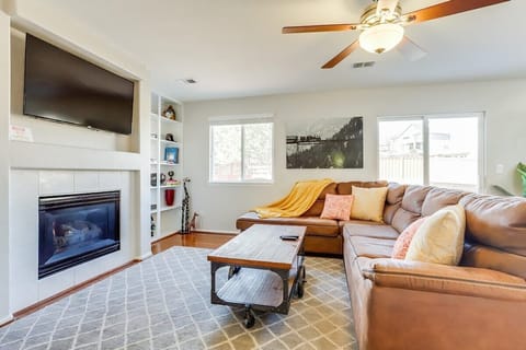 Comfortable, nicely decorated family room with natural sunlight, Roku TV and fireplace