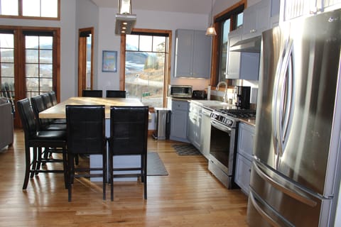 Gourmet kitchen with large island/table and new stainless steel appliances