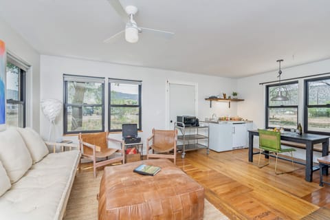 Studio cabins featuring a cozy living room flowing into the kitchen/dining area
