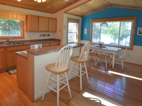 Large Kitchen with table seating for six and two countertop barstools